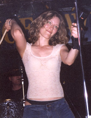 6/22/02: Renee working the cowbell. Photo by Rob Winder.